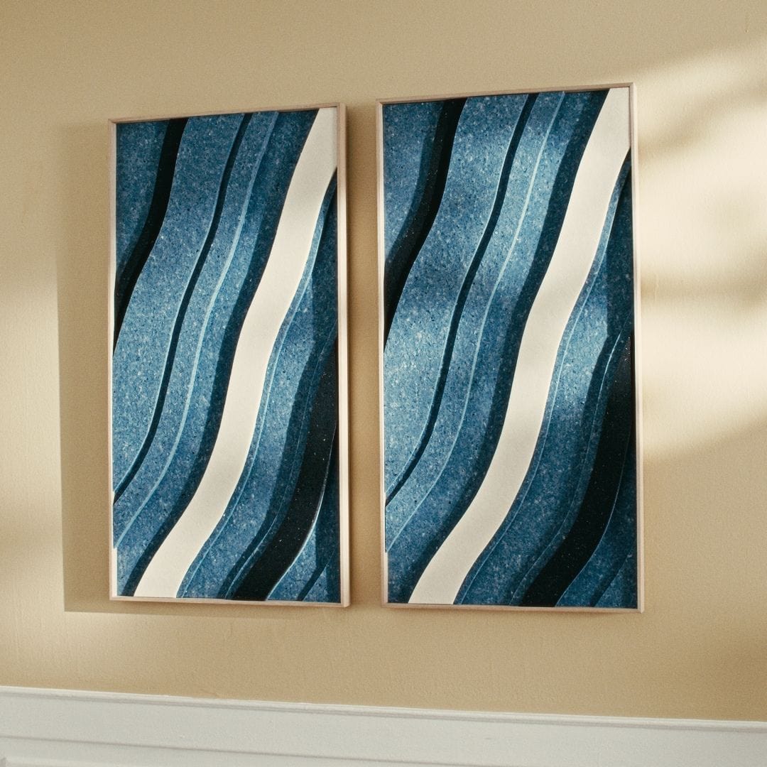 Modern acoustic wall panels in blue and white with wave patterns, enhancing sound absorption and style in living spaces.