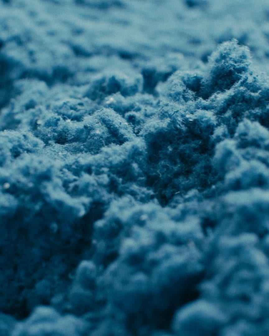 Close-up of porous PET fiber structure used in Arturel acoustic panels to absorb and dissipate sound.